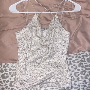 Criss cross in the front tank top. No flaws barely worn.